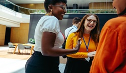 Colleagues laughing together at networking event